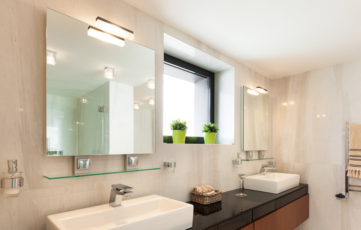 Stylish bathroom with frame less his and hers mirrors.