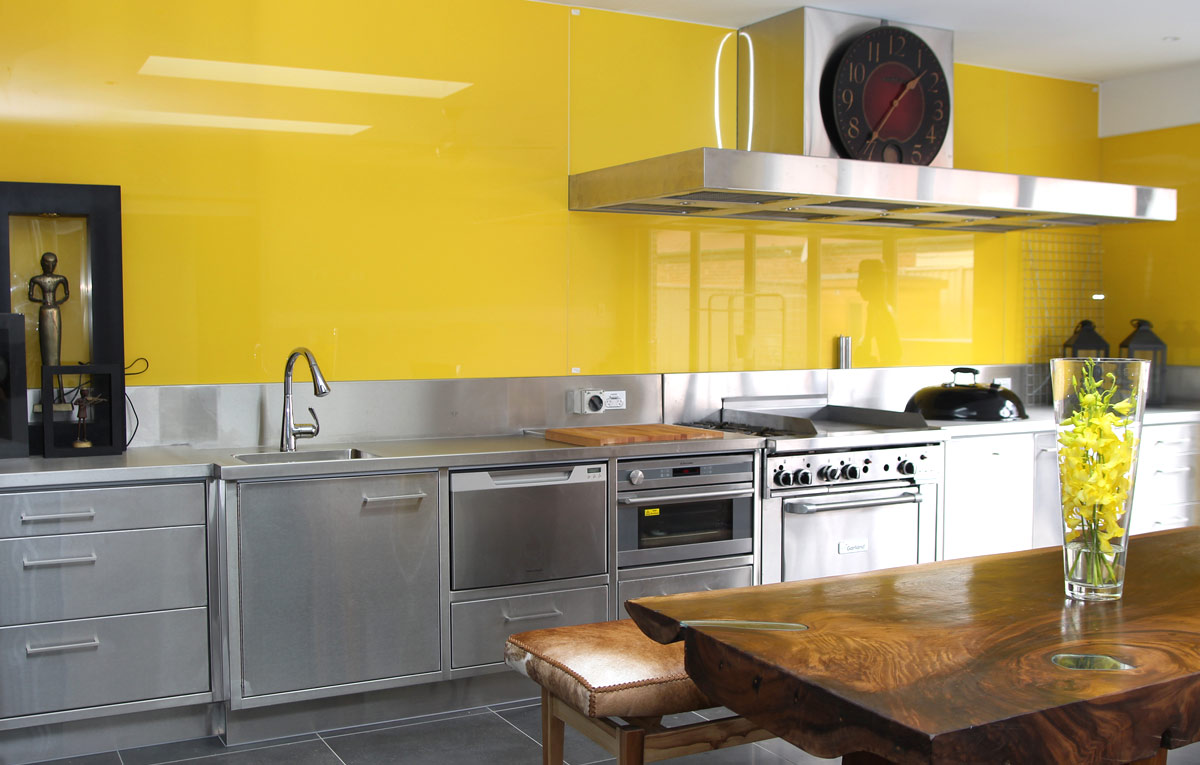 Bright Yellow glass splash back to ceiling.